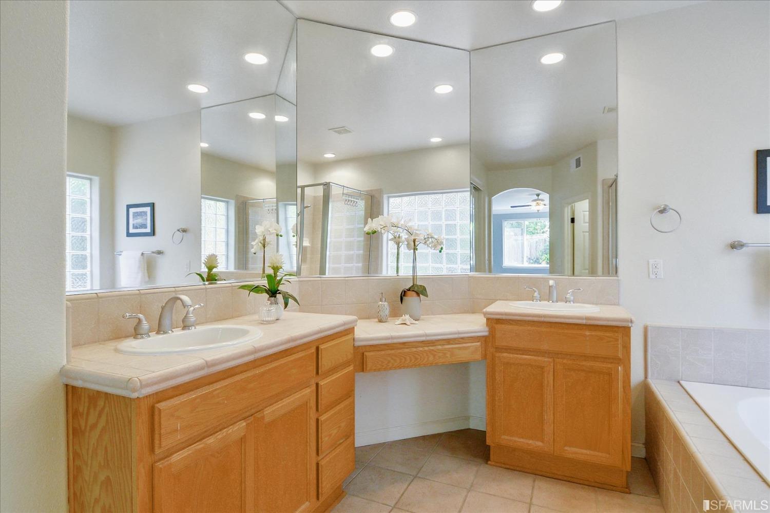 4100 Diorite Court Antioch, CA 94531 - Photo 39 of 58 a bathroom with a sink double vanity mirror and a bathtub