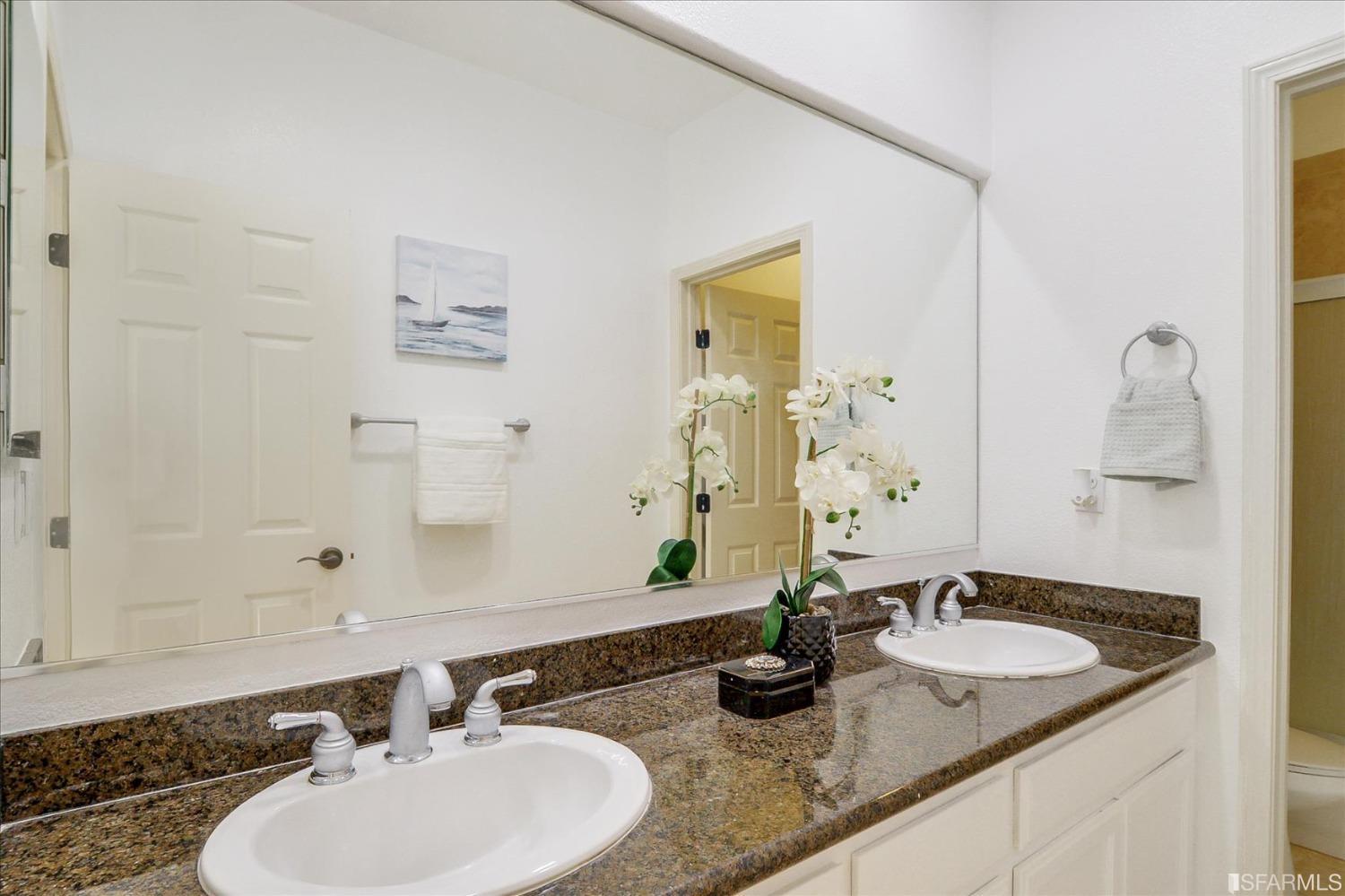 4100 Diorite Court Antioch, CA 94531 - Photo 42 of 58 a bathroom with a granite countertop sink and a mirror