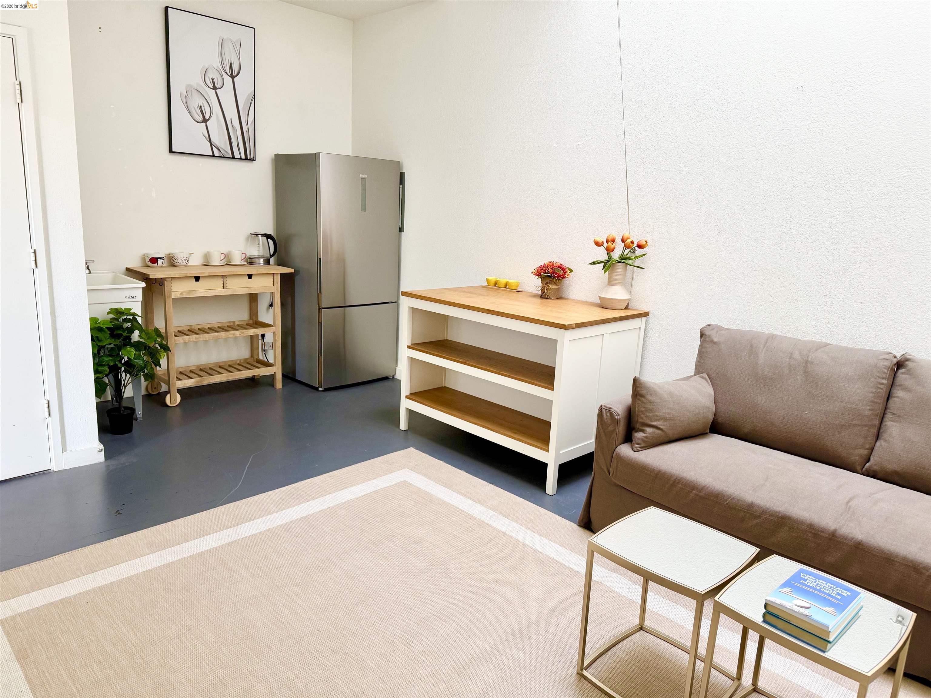 1450 Fourth Street, Unit 5 Berkeley, CA 94710 - Photo 10 of 26 a living room with furniture and a flat screen tv