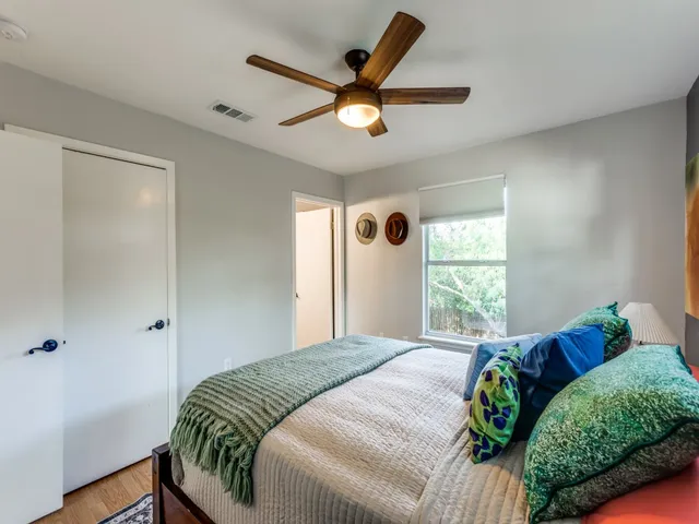 a bedroom with a bed and a window