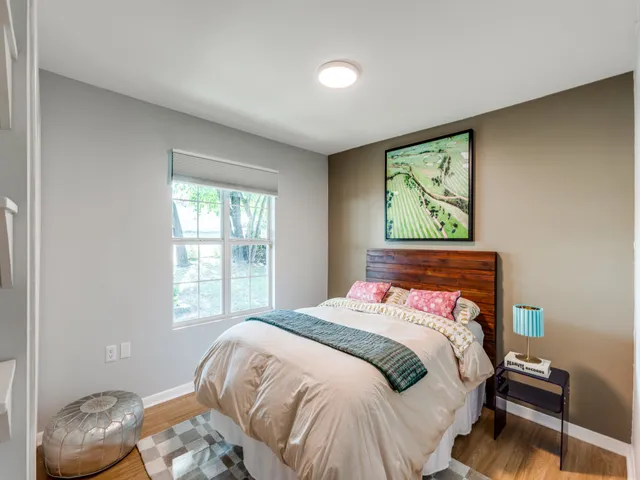 a bedroom with a bed and a window