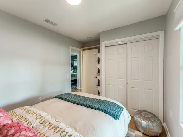 a bedroom with a bed and a closet