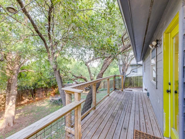 a view of balcony with wooden floor and fence
