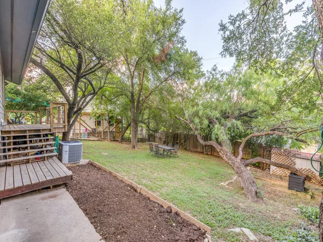 a view of a backyard with large trees