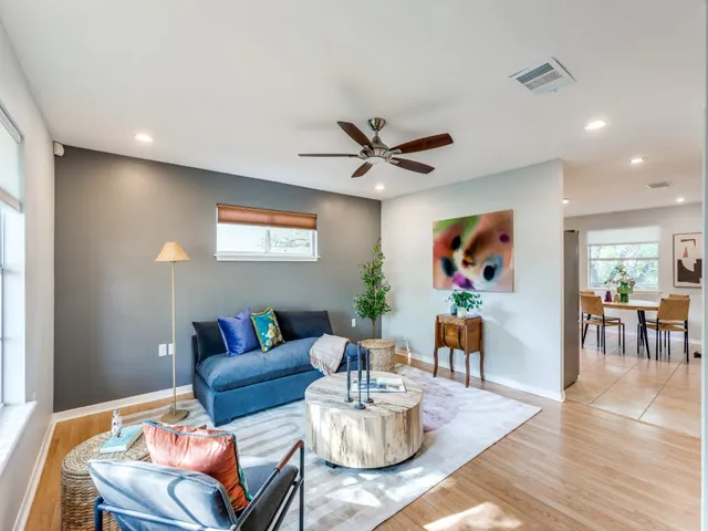 a living room with furniture and wooden floor