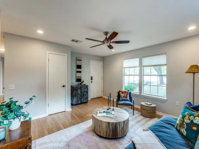 a living room with furniture and a potted plant