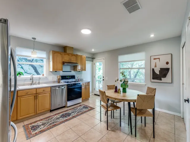 a kitchen with a table and chairs in it