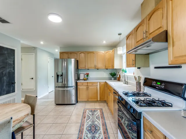 a kitchen with a stove and a refrigerator