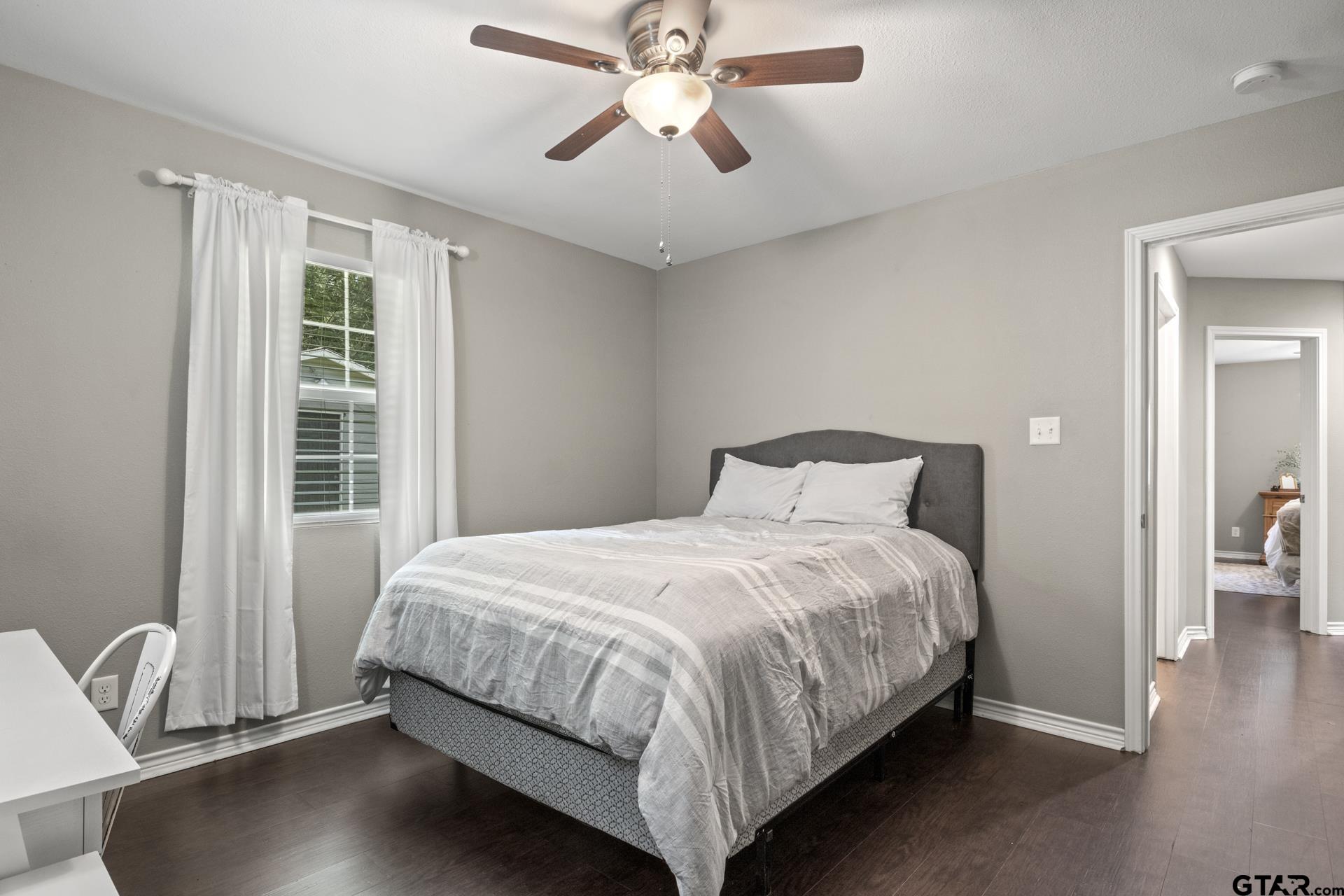655 Daingerfield Street Pittsburg, TX 75686 - Photo 17 of 27 a bedroom with a bed and window