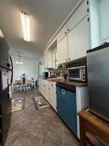 a kitchen with appliances cabinets and furniture
