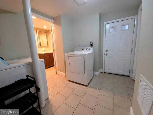 a utility room with cabinets washer and dryer