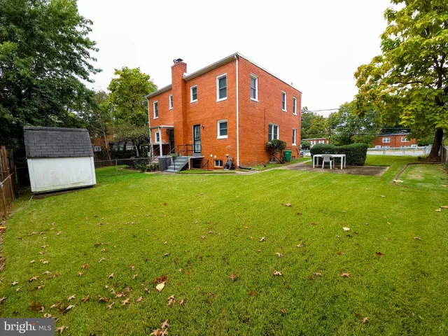 a view of a house with backyard porch and sitting area