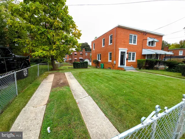 a backyard of a house with barbeque oven table and chairs
