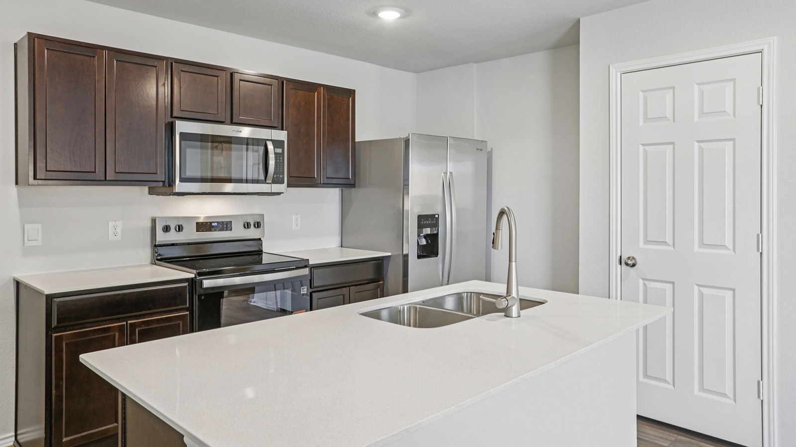 156 Wyatt Way Jarrell, TX 76537 - Photo 4 of 30 Kitchen featuring a center island with a dual basin sink and gooseneck faucet