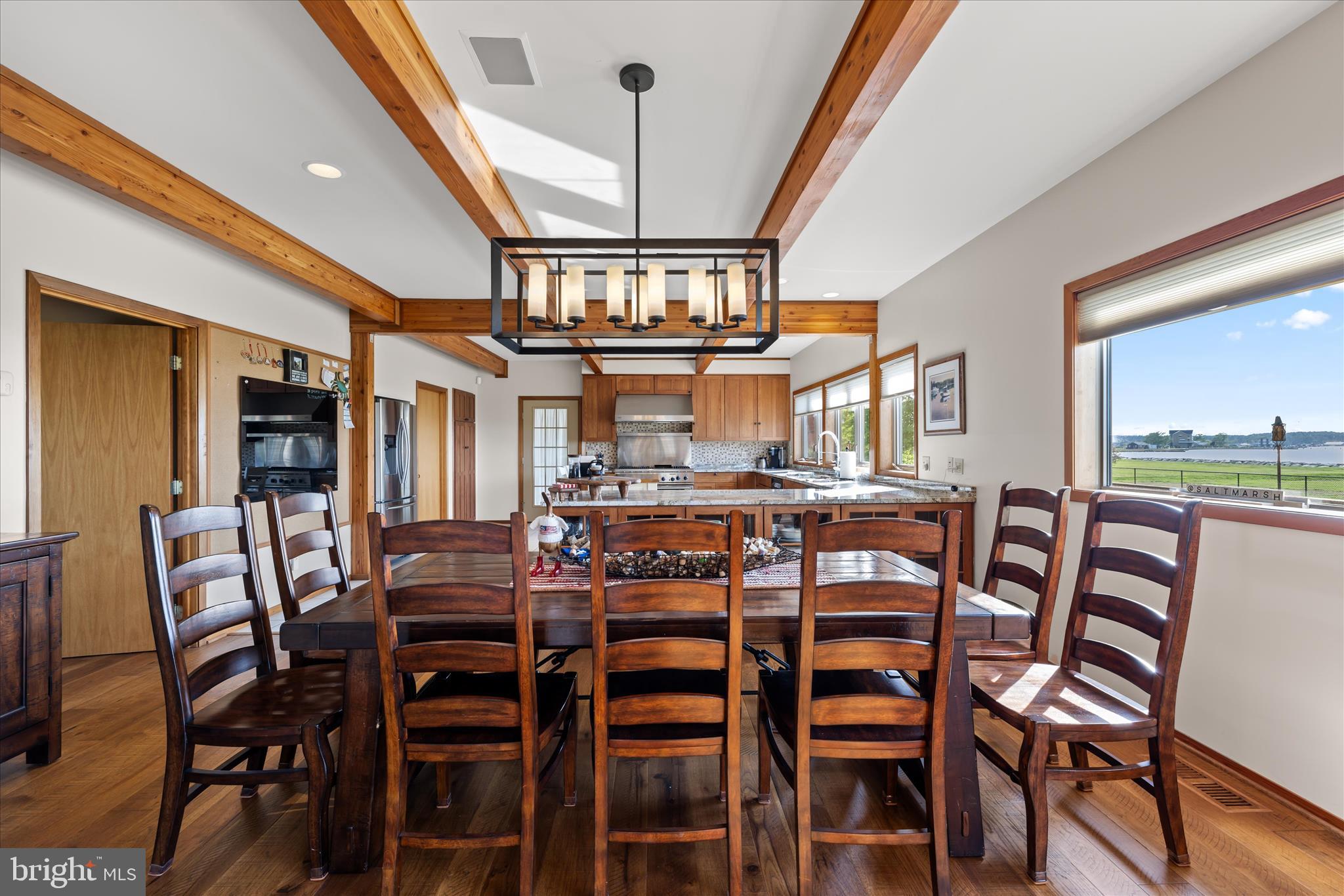 4808 Saltmarsh Lane Madison, MD 21648 - Photo 22 of 119 a view of a dining room with furniture and a floor to ceiling window