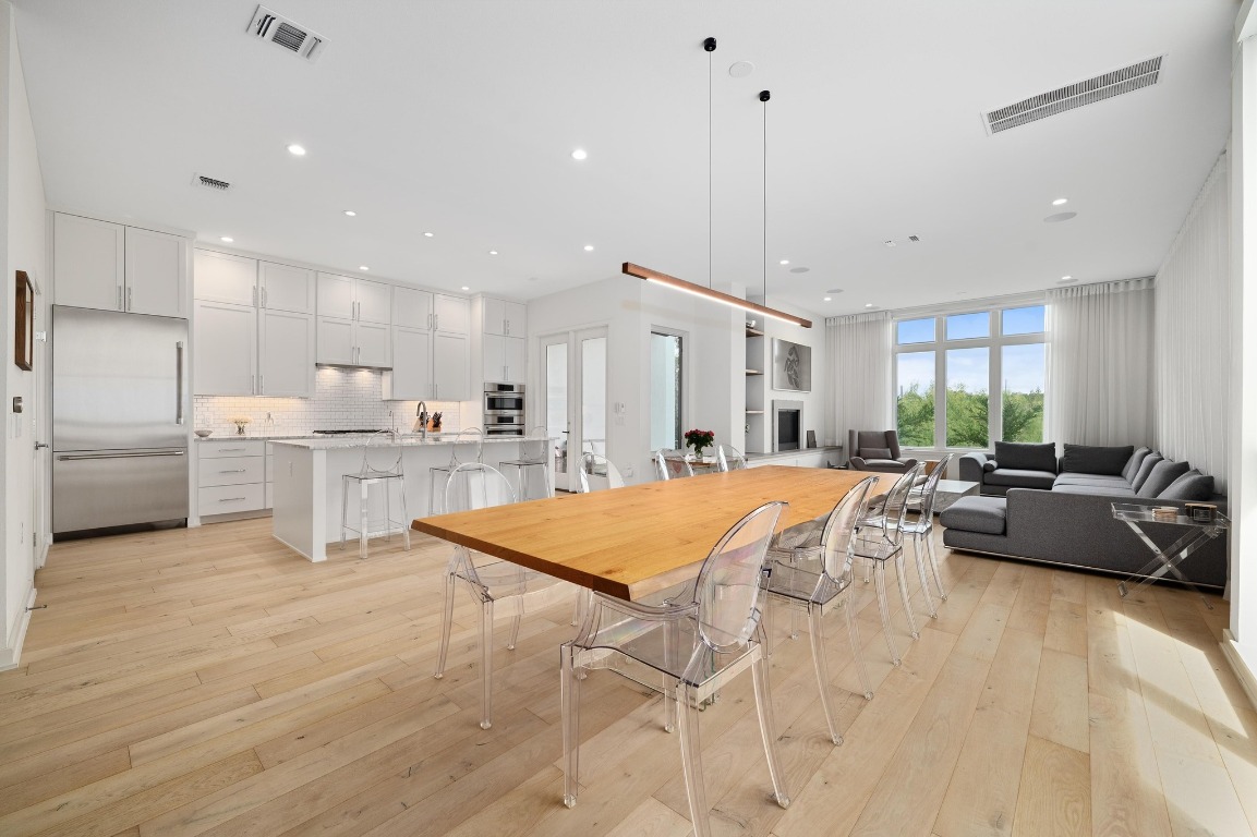 2608 Watkins Way Austin, TX 78746 - Photo 1 of 1 a living room with kitchen island furniture and a wooden floor