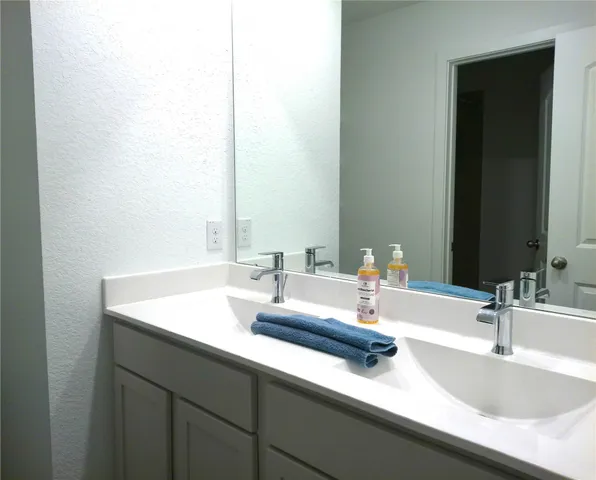 a bathroom with a sink and a mirror