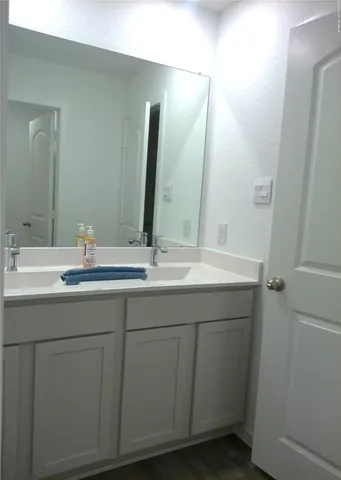 a bathroom with a double vanity sink and a mirror