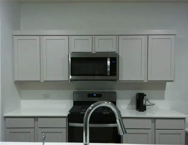 a kitchen with a microwave and cabinets