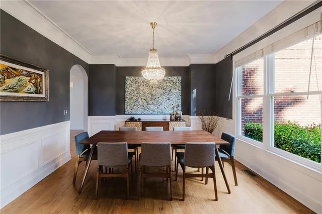 a view of a livingroom with furniture and floor to ceiling window