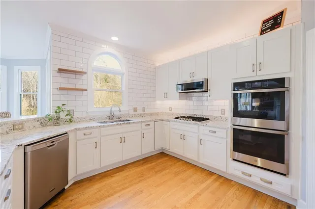 a utility room with a window and washer