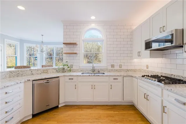 a view of an entryway with wooden floor