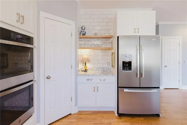 a spacious bathroom with a granite countertop sink a mirror and a