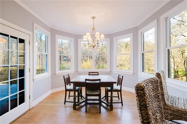 an empty room with a window and a ceiling fan