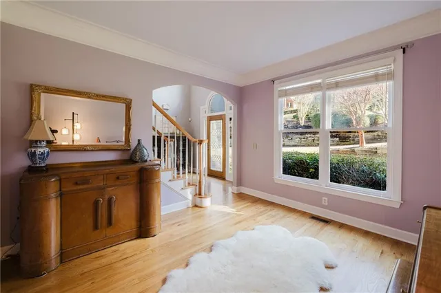 a kitchen with stainless steel appliances kitchen island wooden floors and white cabinets