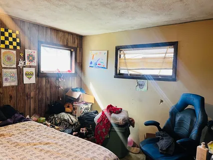 a bedroom with a bed and a window