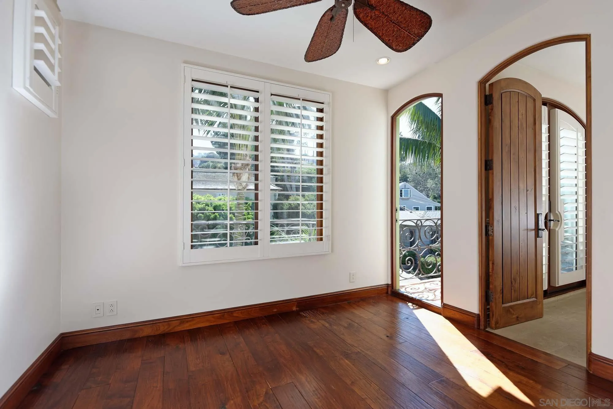 1908 Hypatia Way La Jolla, CA 92037 - Photo 21 of 29 an empty room with wooden floor fan and windows