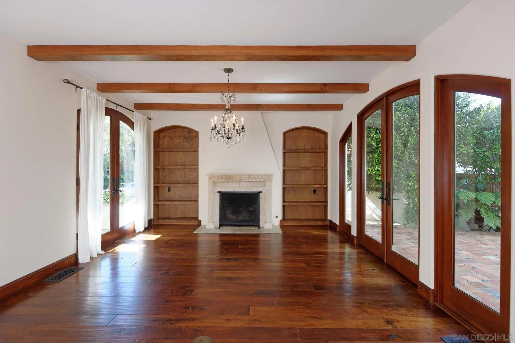 1908 Hypatia Way La Jolla, CA 92037 - Photo 8 of 29 a view of empty room with wooden floor and fireplace