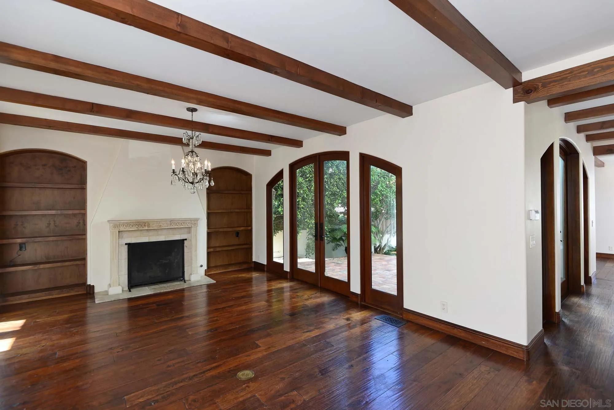 1908 Hypatia Way La Jolla, CA 92037 - Photo 10 of 29 a view of an empty room with wooden floor fireplace and a window