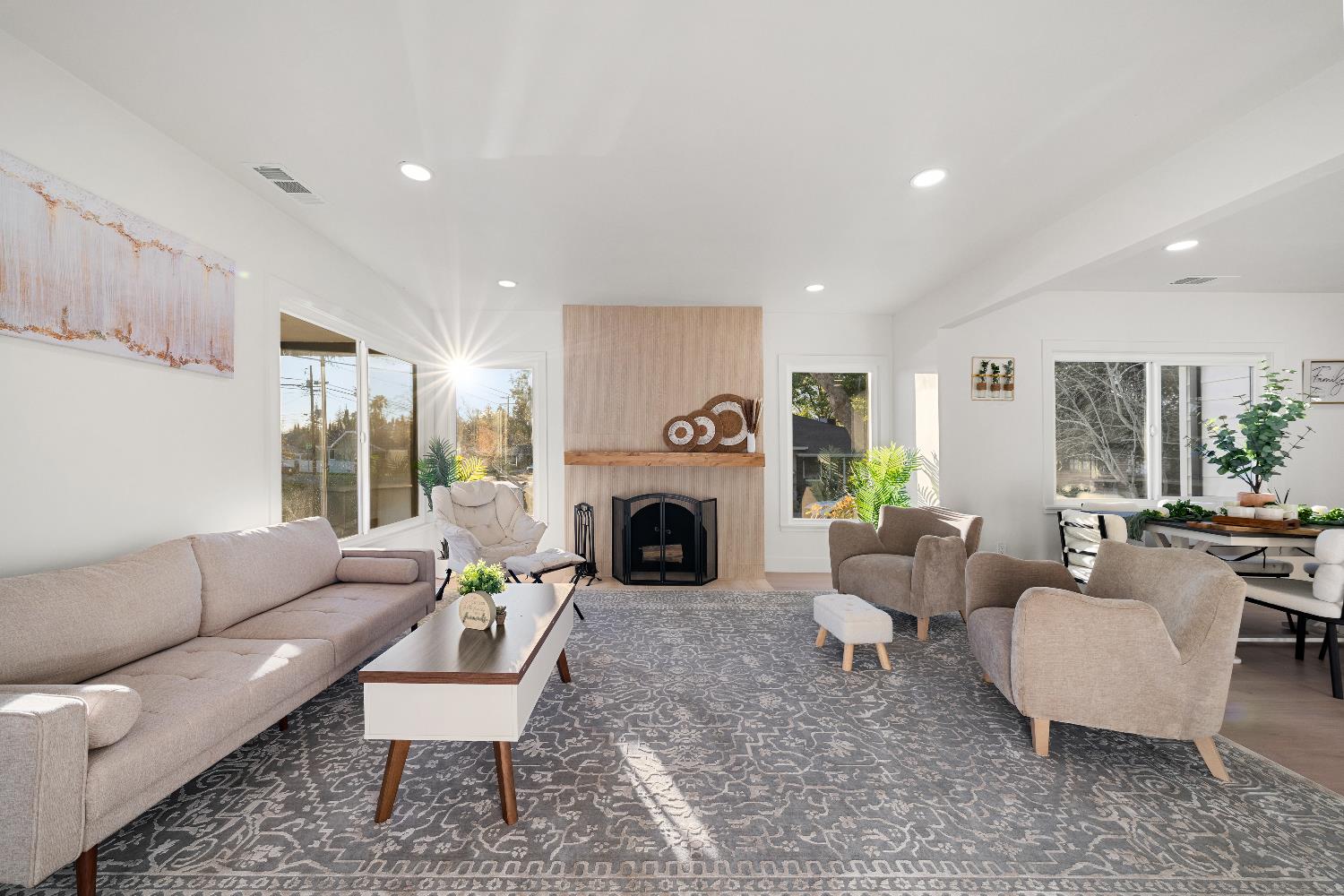 5401 J Street Sacramento, CA 95819 - Photo 11 of 71 a living room with furniture a fireplace and a large window