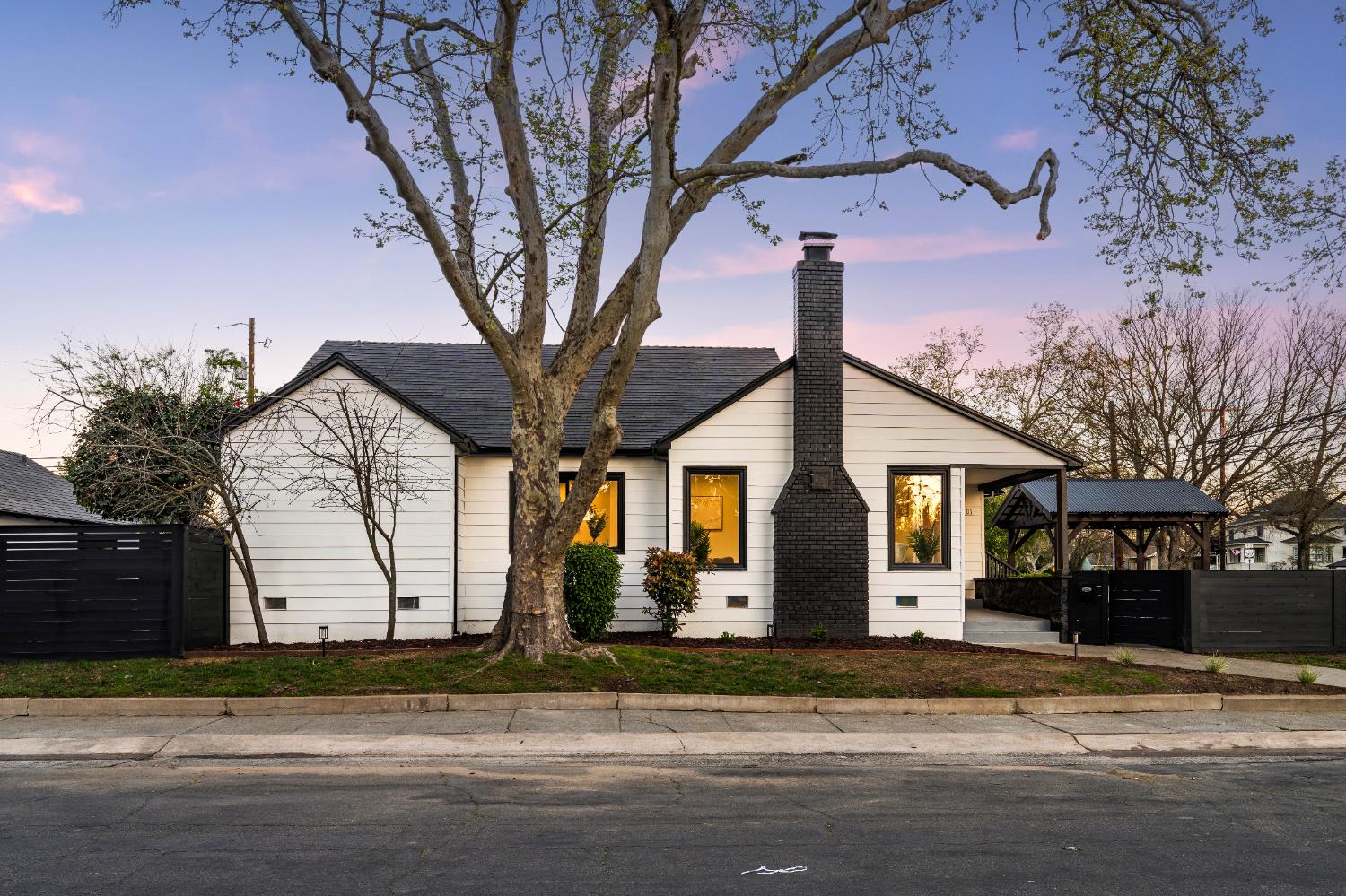 5401 J Street Sacramento, CA 95819 - Photo 2 of 71 a front view of a house with a yard and garage