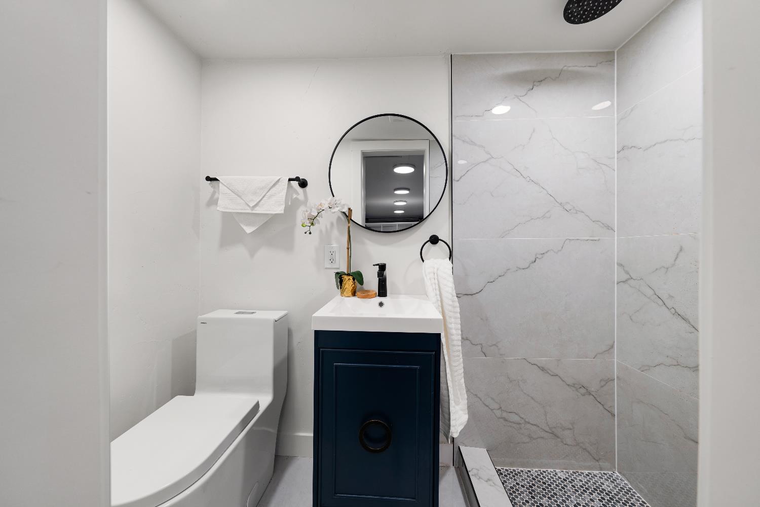 5401 J Street Sacramento, CA 95819 - Photo 47 of 71 a bathroom with a sink a toilet and a shower