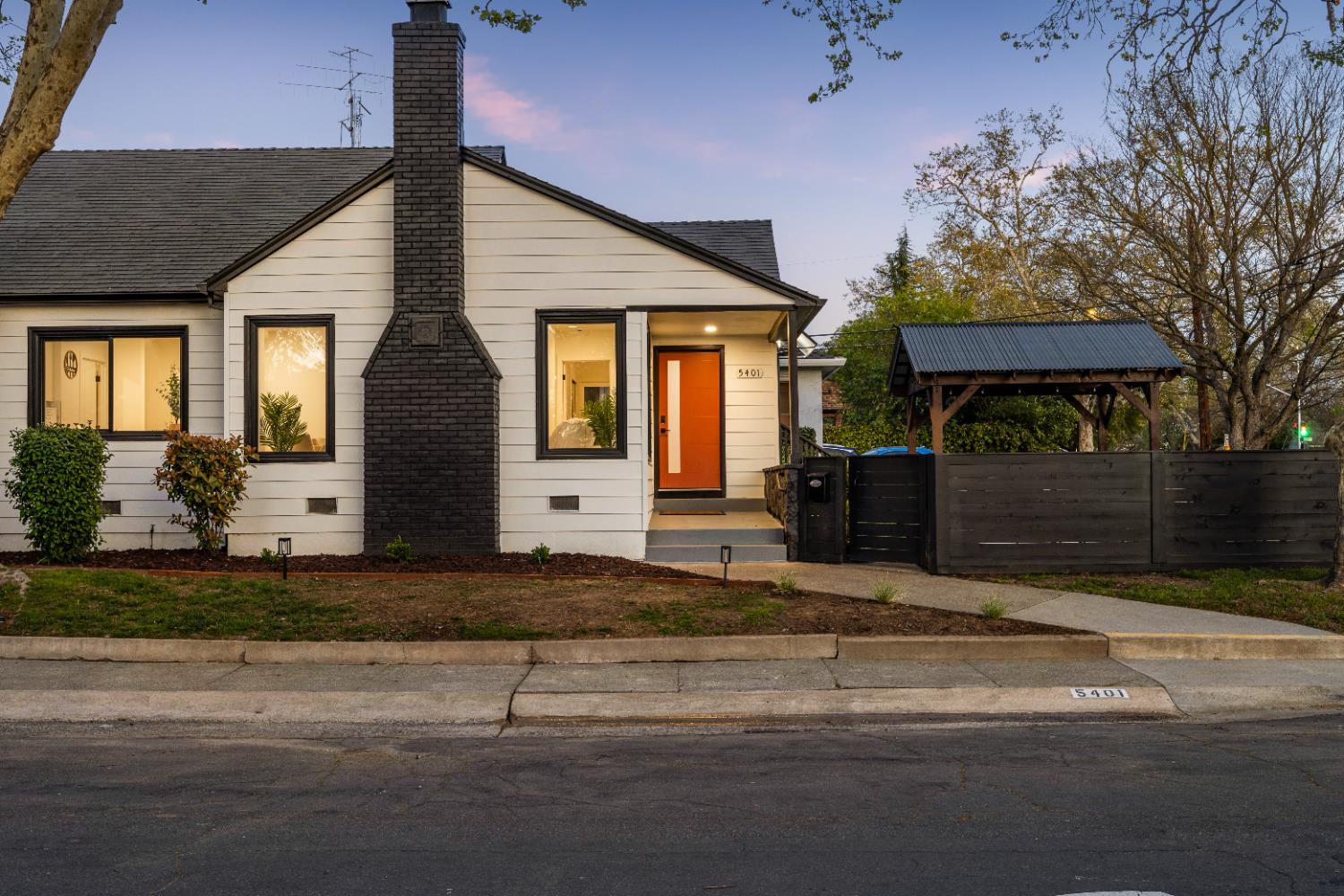 5401 J Street Sacramento, CA 95819 - Photo 50 of 71 a front view of a house with a yard