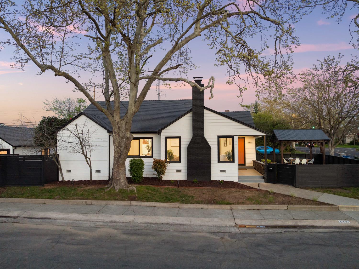 5401 J Street Sacramento, CA 95819 - Photo 70 of 71 a front view of a house with a yard and garage