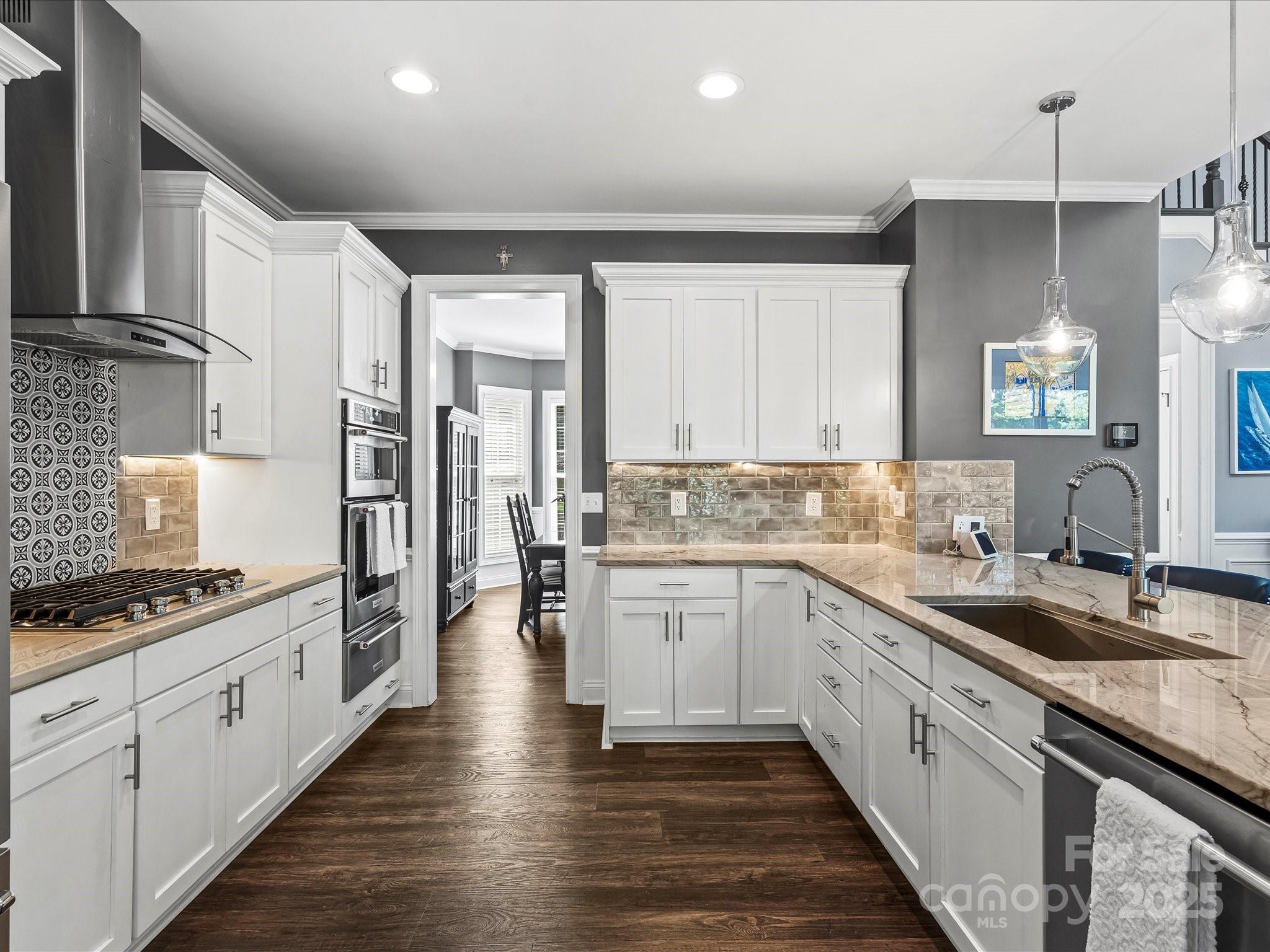 172 Beaten Path Road Mooresville, NC 28117 - Photo 12 of 48 a kitchen with white cabinets and appliances