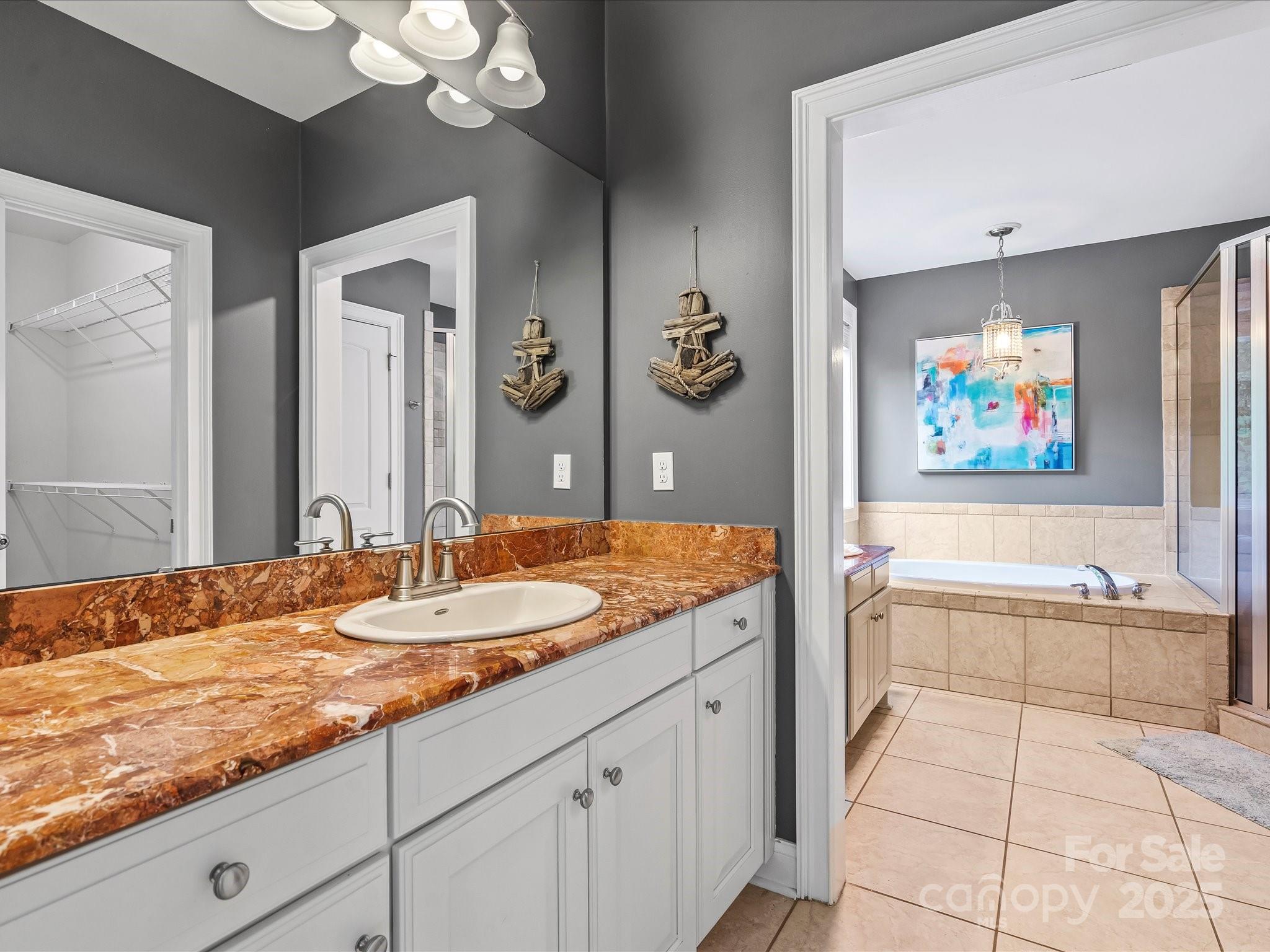172 Beaten Path Road Mooresville, NC 28117 - Photo 17 of 48 a bathroom with a granite countertop sink mirror and a bath tub