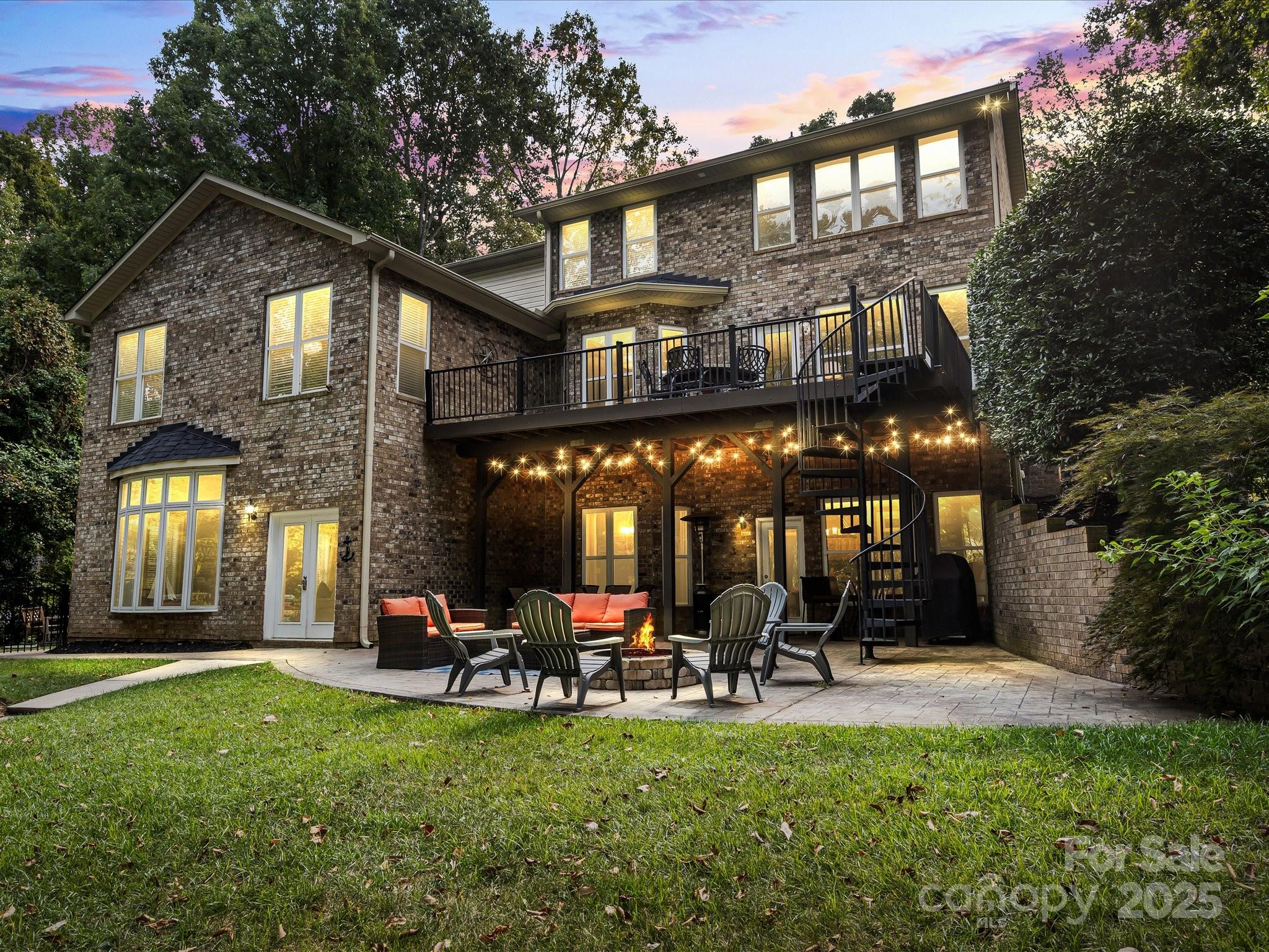 172 Beaten Path Road Mooresville, NC 28117 - Photo 2 of 48 a view of a chairs and table in patio with a table and chairs under an umbrella