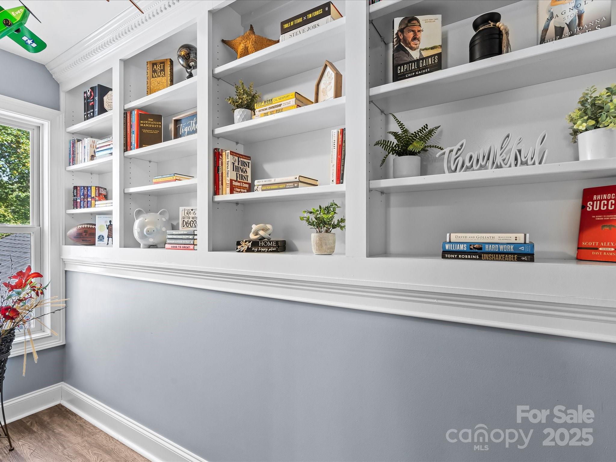 172 Beaten Path Road Mooresville, NC 28117 - Photo 24 of 48 a shelf with books and knick knacks on it