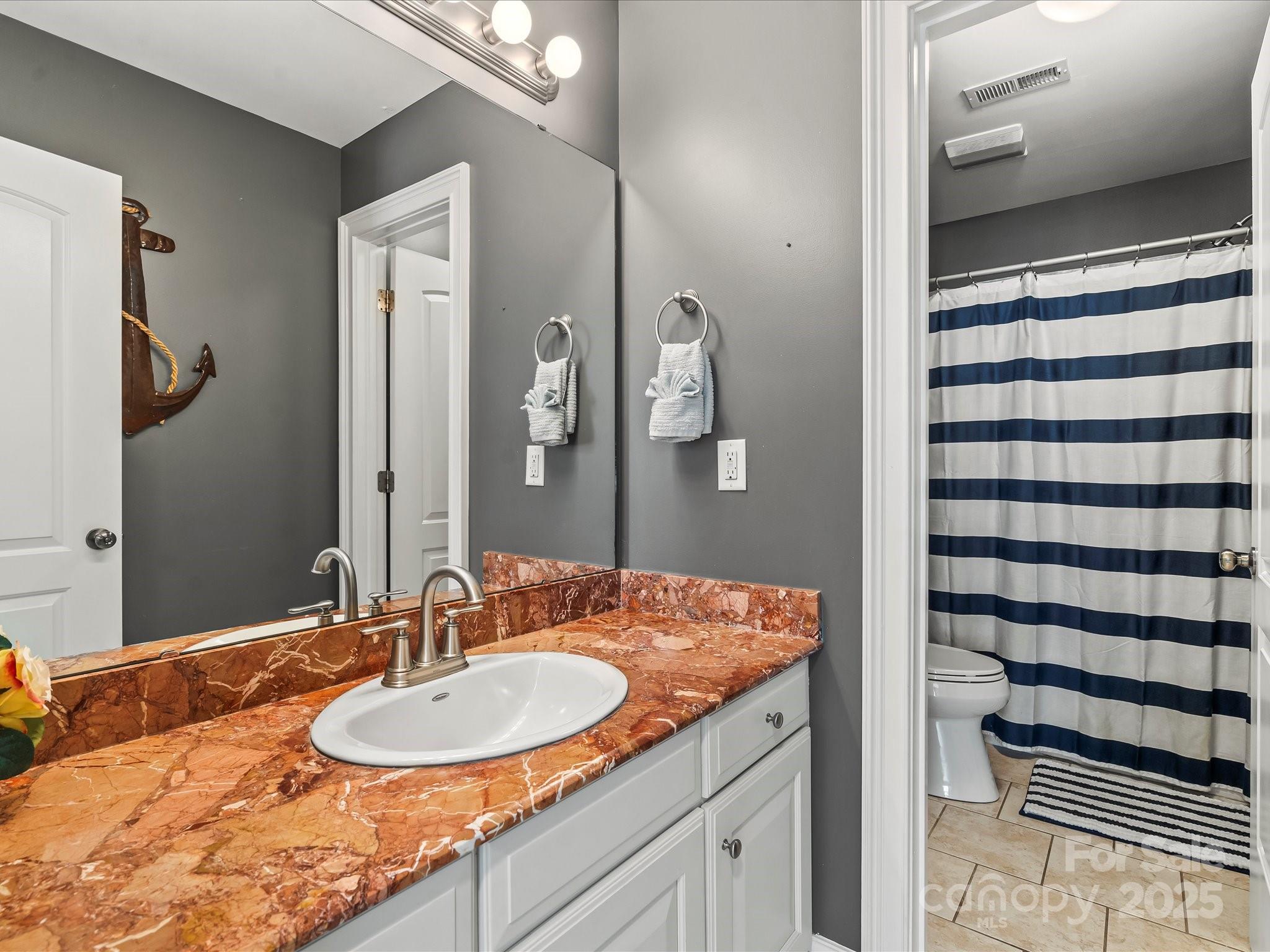 172 Beaten Path Road Mooresville, NC 28117 - Photo 28 of 48 a bathroom with a granite countertop sink and a mirror