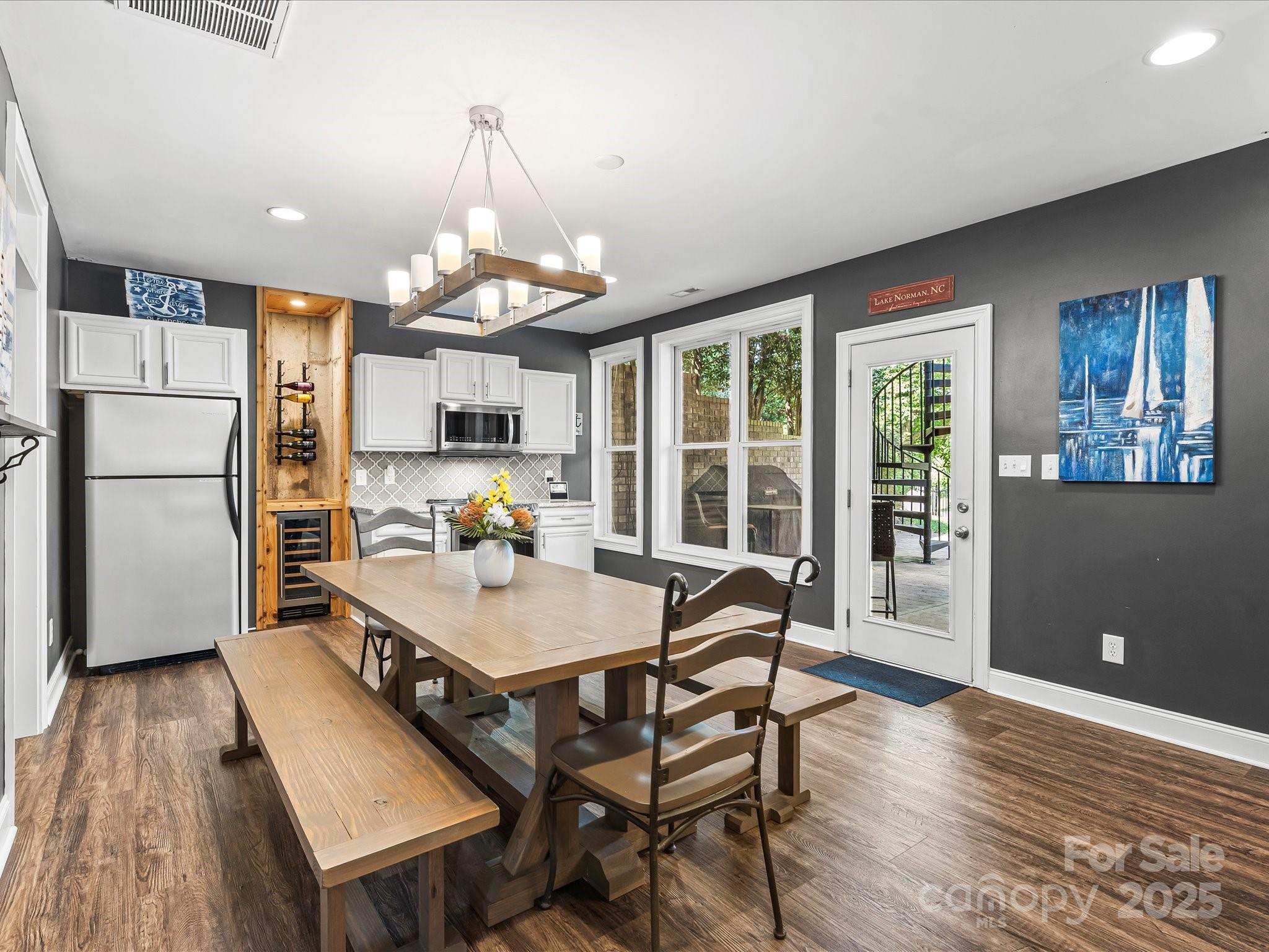 172 Beaten Path Road Mooresville, NC 28117 - Photo 35 of 48 a dining room with wooden floor and a refrigerator
