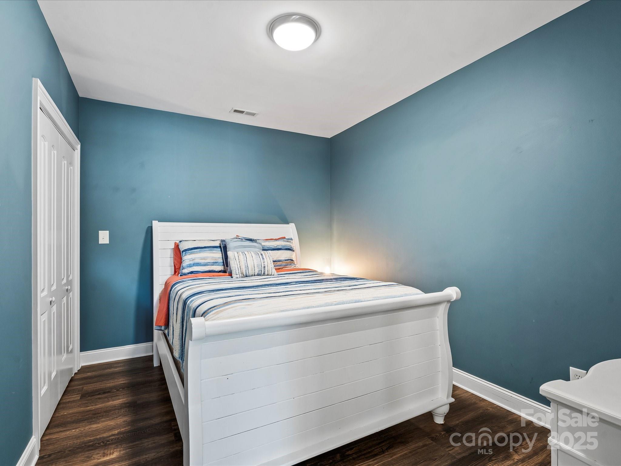 172 Beaten Path Road Mooresville, NC 28117 - Photo 36 of 48 a bedroom with a bed and wooden floor