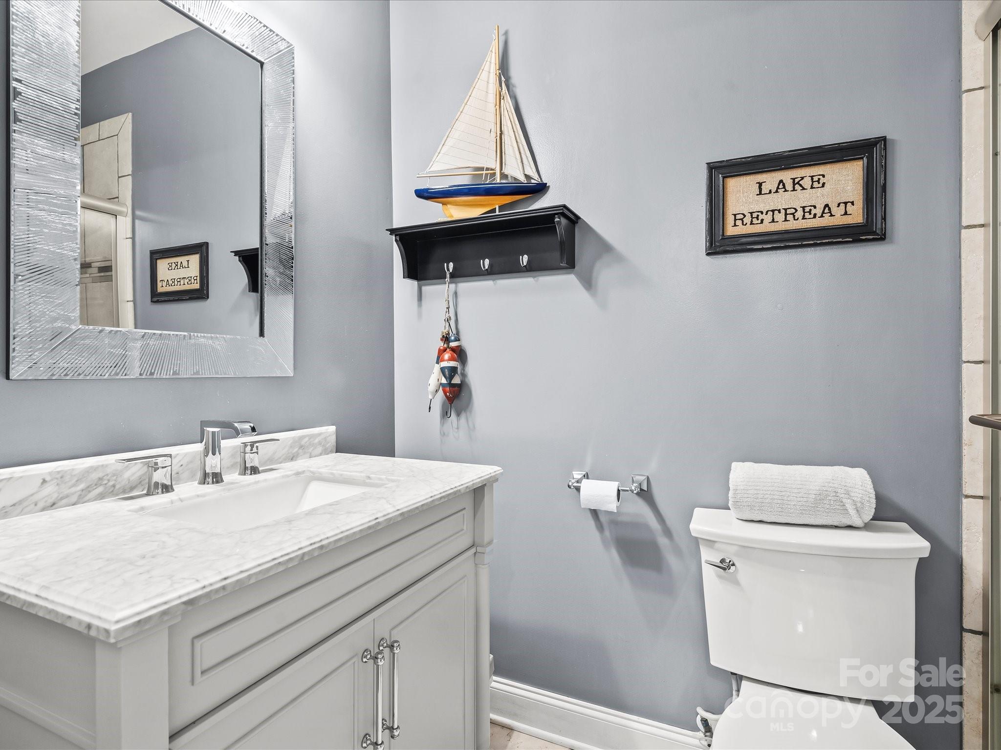 172 Beaten Path Road Mooresville, NC 28117 - Photo 38 of 48 a bathroom with a sink a toilet and mirror