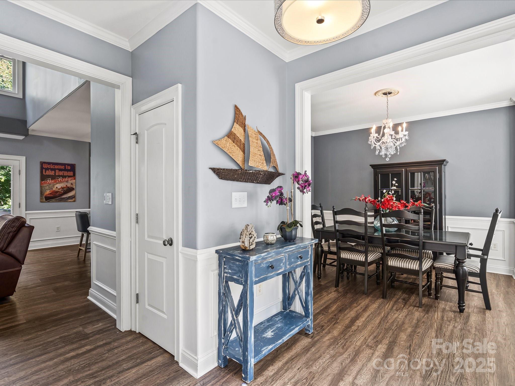 172 Beaten Path Road Mooresville, NC 28117 - Photo 6 of 48 a view of a dining room with furniture wooden floor and a chandelier