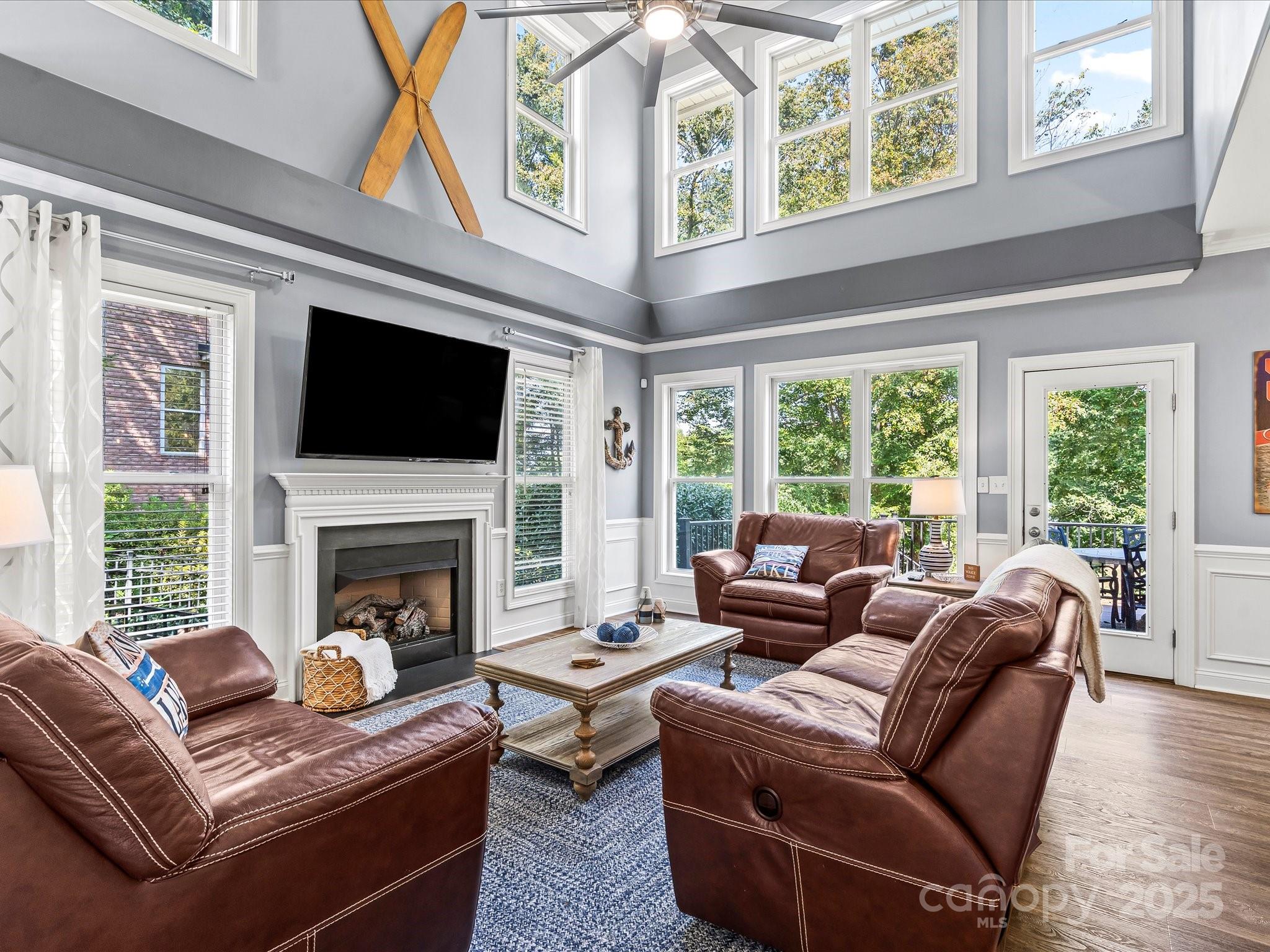 172 Beaten Path Road Mooresville, NC 28117 - Photo 7 of 48 a living room with furniture a flat screen tv and a fireplace