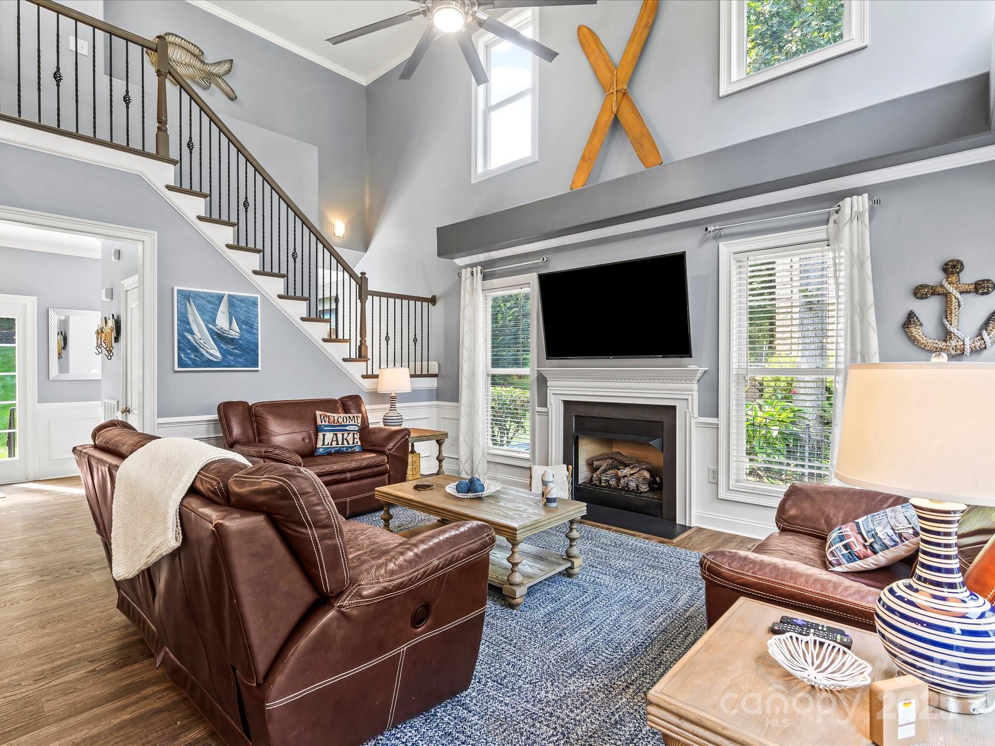 172 Beaten Path Road Mooresville, NC 28117 - Photo 8 of 48 a living room with furniture fireplace and a flat screen tv