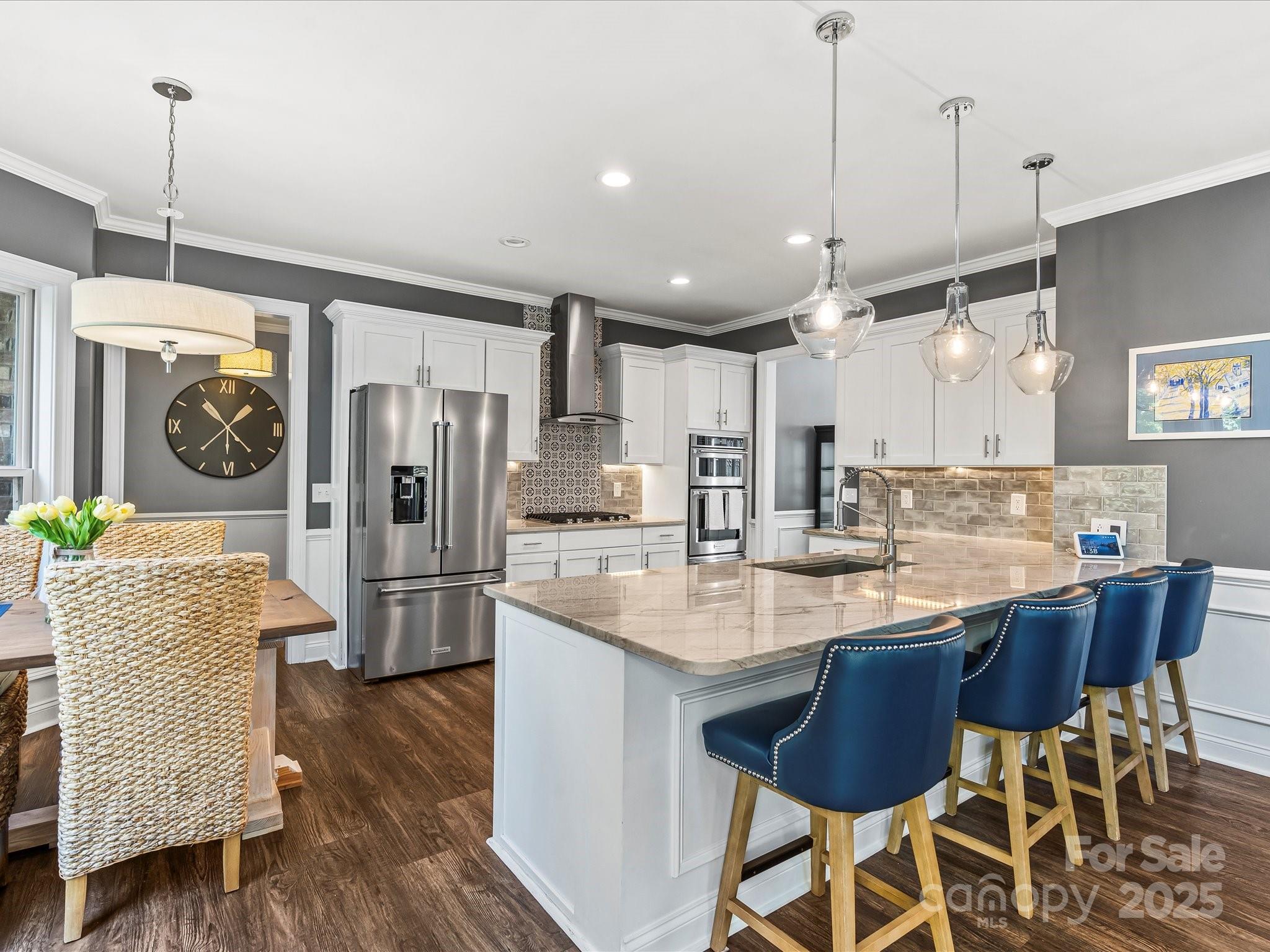 172 Beaten Path Road Mooresville, NC 28117 - Photo 10 of 48 a kitchen with stainless steel appliances granite countertop a refrigerator a sink dishwasher a dining table and chairs with wooden floor